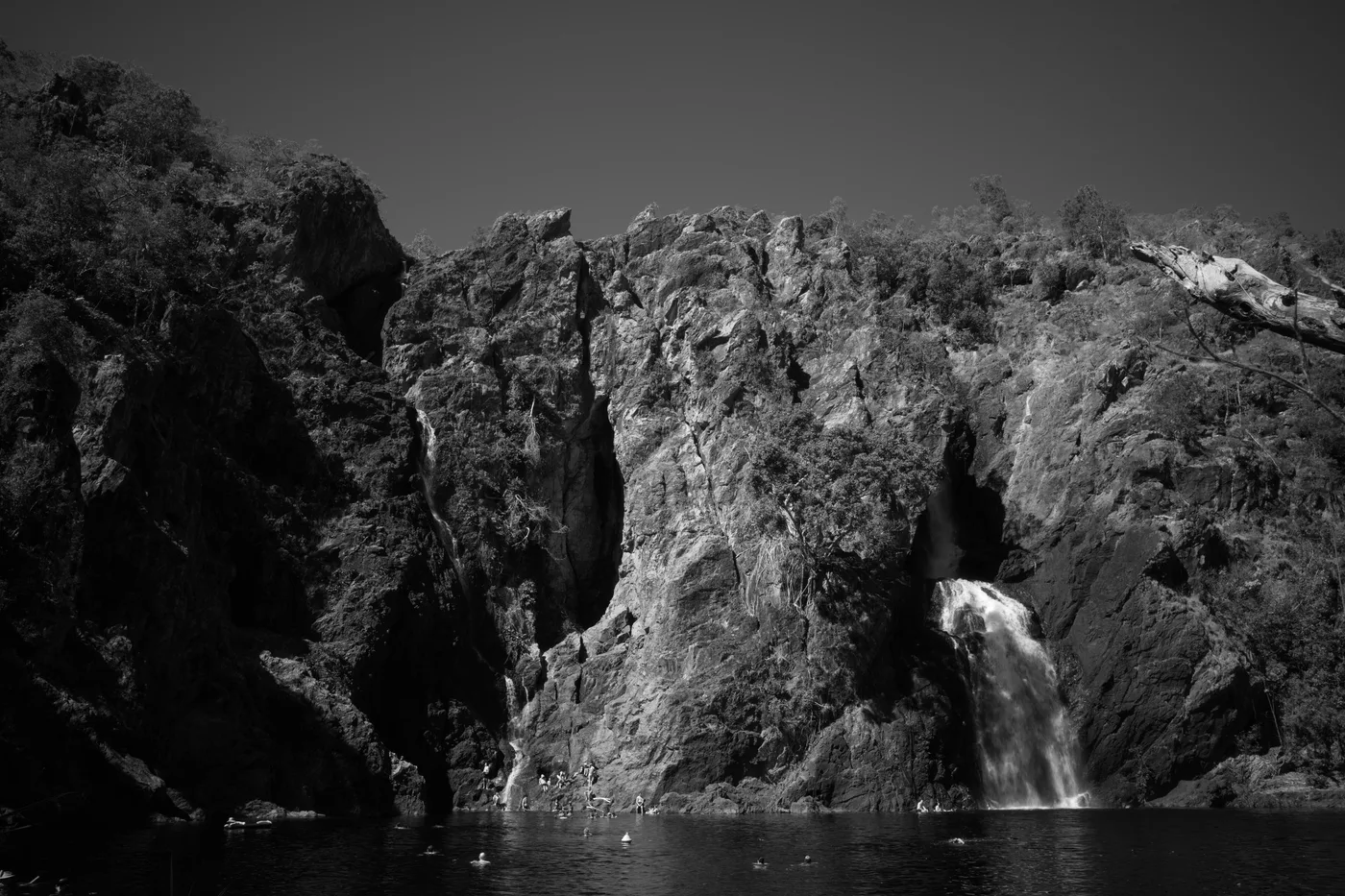 a black and white photograph of two waterfalls